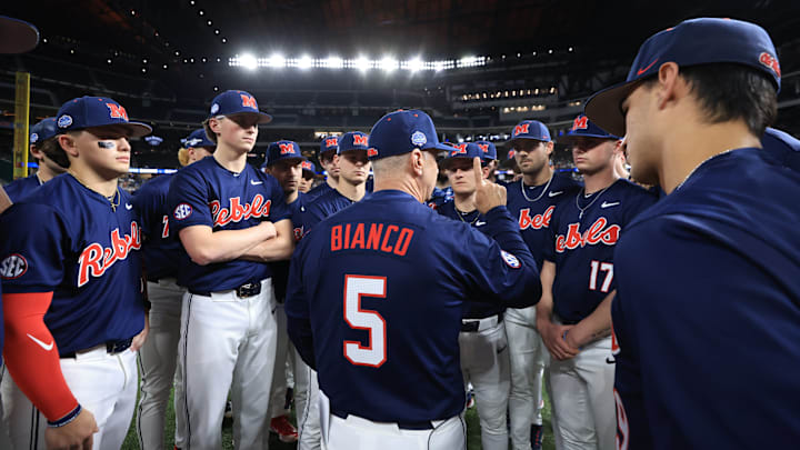 Ole Miss baseball coach Mike Bianco talks to players before the game against the Texas Longhorns at the Shriners Children's College Showdown in Arlington, Texas.