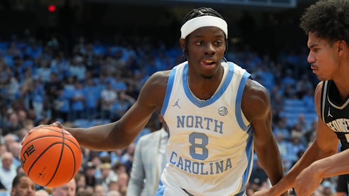 Dec 7, 2025; Chapel Hill, North Carolina, USA; North Carolina Tar Heels forward Caleb Wilson (8) with the ball as Georgetown Hoyas forward Isaiah Abraham (7) defends in the second half at Dean E. Smith Center. Mandatory Credit: Bob Donnan-Imagn Images Dec 7, 2025; Chapel Hill, North Carolina, USA; North Carolina Tar Heels forward Caleb Wilson (8) with the ball as Georgetown Hoyas forward Isaiah Abraham (7) defends in the second half at Dean E. Smith Center. Mandatory Credit: Bob Donnan-Imagn Images