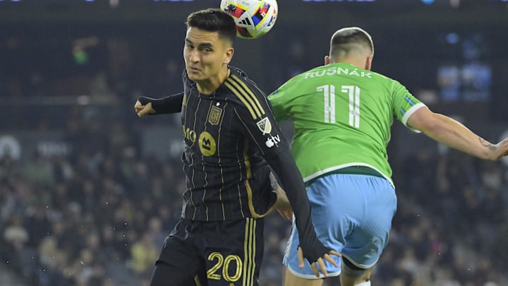 Nov 23, 2024; Los Angeles, California, USA; LAFC midfielder Eduard Atuesta (20) and Seattle Sounders FC midfielder Albert Rusnak (11) jump to head the ball in the first half in a 2024 MLS Cup western conference semifinal match at BMO Stadium. Mandatory Credit: Jayne Kamin-Oncea-Imagn Images