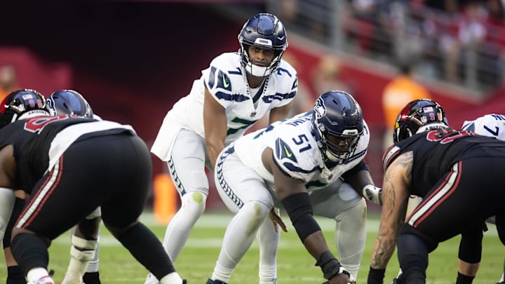 Dec 8, 2024; Glendale, Arizona, USA; Seattle Seahawks center Olu Oluwatimi (51) prepares to snap the ball to quarterback Geno Smith (7) against the Arizona Cardinals at State Farm Stadium. Mandatory Credit: Mark J. Rebilas-Imagn Images Dec 8, 2024; Glendale, Arizona, USA; Seattle Seahawks center Olu Oluwatimi (51) prepares to snap the ball to quarterback Geno Smith (7) against the Arizona Cardinals at State Farm Stadium. Mandatory Credit: Mark J. Rebilas-Imagn Images