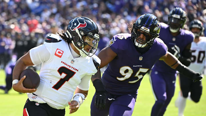 Oct 5, 2025; Baltimore, Maryland, USA; Houston Texans quarterback C.J. Stroud (7) runs for a gain past Baltimore Ravens linebacker Tavius Robinson (95) during the second quarter at M&T Bank Stadium. Mandatory Credit: Rafael Suanes-Imagn Images