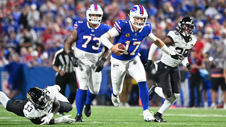 Buffalo Bills quarterback Josh Allen (17) runs for a first down against the Jacksonville Jaguars in the second quarter at Highmark Stadium. 