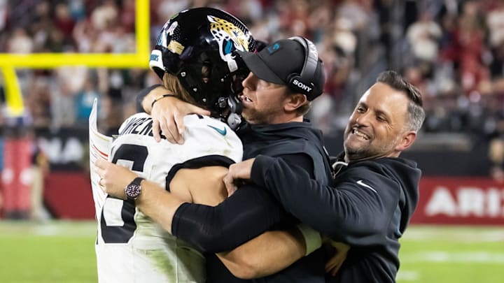 Nov 23, 2025; Glendale, Arizona, USA; Jacksonville Jaguars quarterback Trevor Lawrence (16) celebrates with head coach Liam Coen after defeating the Arizona Cardinals at State Farm Stadium. Mandatory Credit: Mark J. Rebilas-Imagn Images