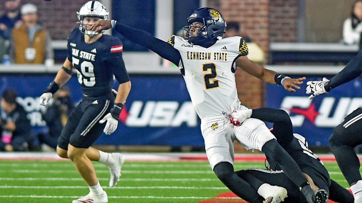 Kennesaw State quarterback Amari Odom tries to avoid a sack by Jax State's Talan Carter during the C-USA Championship