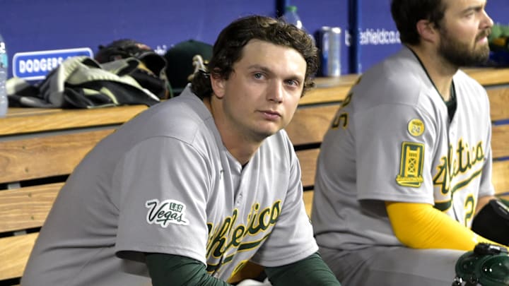May 15, 2025; Los Angeles, California, USA;  Athletics first baseman Nick Kurtz (16) and catcher Shea Langeliers (23) sit in the dugout during 19-2 loss against the Los Angeles Dodgers at Dodger Stadium. Mandatory Credit: Jayne Kamin-Oncea-Imagn Images
