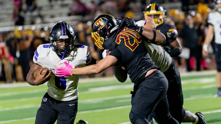 Millennium Tigers Dmari Bryant (6) runs with the ball against the Tolleson Wolverines during a game at Tolleson Union High School in Tolleson on Oct. 9, 2025.