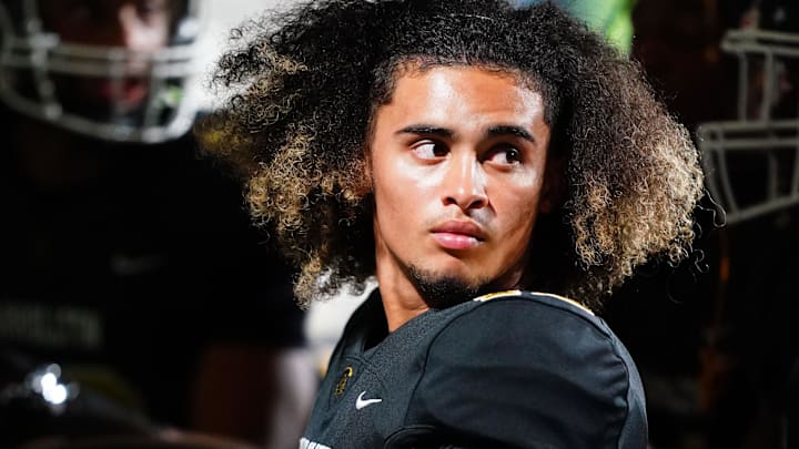 Oct 20, 2023; Carrollton, GA, USA; Carrollton Trojans quarterback Julian Lewis (10) watches on from