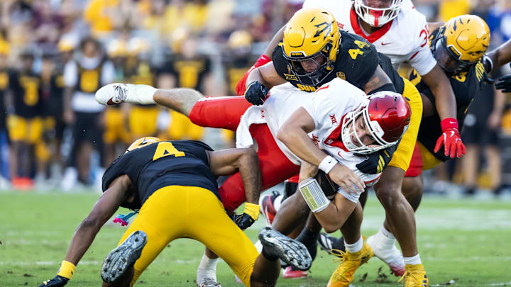 Oct 25, 2025; Tempe, Arizona, USA; Houston Cougars quarterback Conner Weigman (1) is tackled by Arizona State Sun Devils linebacker Keyshaun Elliott (44) in the first half at Mountain America Stadium. Mandatory Credit: Mark J. Rebilas-Imagn Images