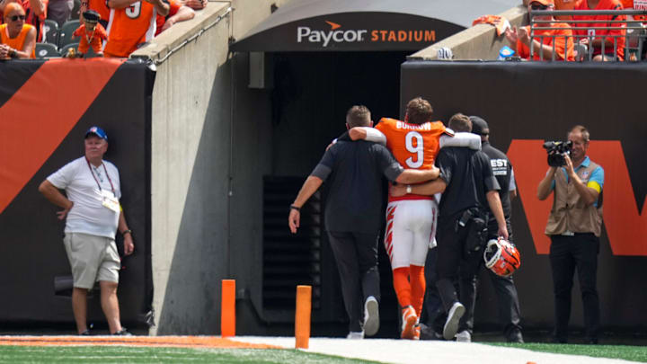 Cincinnati Bengals quarterback Joe Burrow (9) is assisted to the locker room with an injury in the second quarter of the NFL Week 2 game between the Cincinnati Bengals and the Jacksonville Jaguars at Paycor Stadium in downtown Cincinnati on Sunday, Sept. 14, 2025. The Jaguars led 17-10 at halftime.