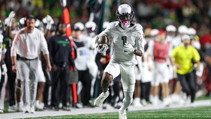 Oct 18, 2025; Piscataway, New Jersey, USA;  Oregon Ducks wide receiver Dakorien Moore (1) gains yards after catch during the first half against the Rutgers Scarlet Knights at SHI Stadium. Mandatory Credit: Vincent Carchietta-Imagn Images