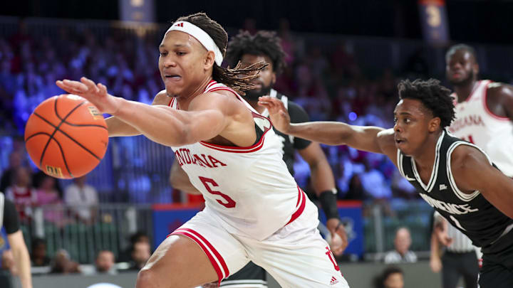 Indiana Hoosiers forward Malik Reneau (5) stretches for the ball as Providence Friars guard Jayden Pierre (1) defends during the first half at Imperial Arena at the Atlantis resort. Indiana Hoosiers forward Malik Reneau (5) stretches for the ball as Providence Friars guard Jayden Pierre (1) defends during the first half at Imperial Arena at the Atlantis resort.