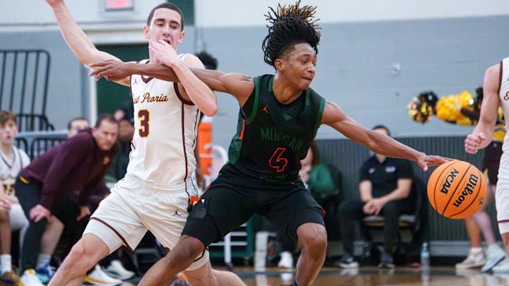 East Peoria’s Cole DuBois, left, tangles with Morgan Park’s Daniel Wallace in the first half of their high school basketball game at the Peoria Showtime Classic on Saturday, Jan. 10, 2026 at Richwoods High School. The Raiders routed the Mustangs 71-45.