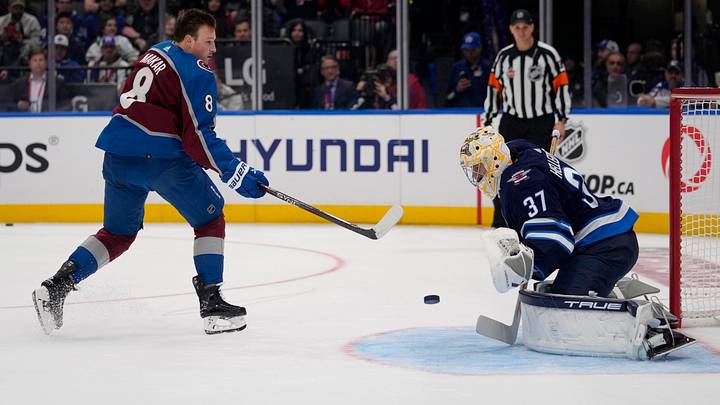 Feb 2, 2024; Toronto, Ontario, CANADA; Winnipeg Jets goalkeeper Connor Hellebuyck (37) makes a save against Colorado Avalanche defenseman Cale Makar (8) during the NHL All-Star Skills Competition at Scotiabank Arena. Mandatory Credit: John E. Sokolowski-USA TODAY Sports