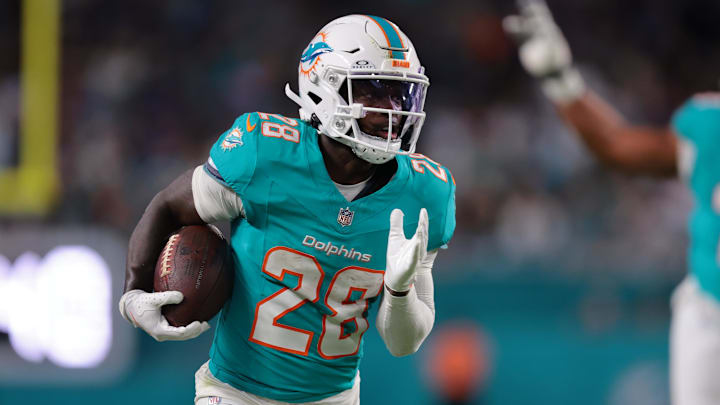 Miami Dolphins running back De'Von Achane (28) runs for a gain during the first quarter against the Baltimore Ravens at Hard Rock Stadium. 