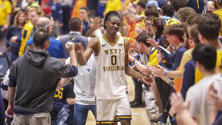 Mar 6, 2026; Morgantown, West Virginia, USA; West Virginia Mountaineers forward Brenen Lorient (0) celebrates with fans after defeating the UCF Knights at Hope Coliseum. Mandatory Credit: Ben Queen-Imagn Images