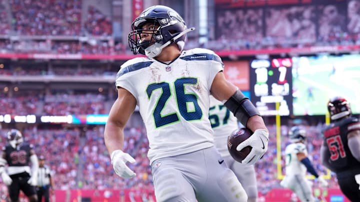 Dec 8, 2024; Glendale, Arizona, USA; Seattle Seahawks running back Zach Charbonnet (26) runs for a touchdown against the Arizona Cardinals during the first half at State Farm Stadium. Mandatory Credit: Joe Camporeale-Imagn Images