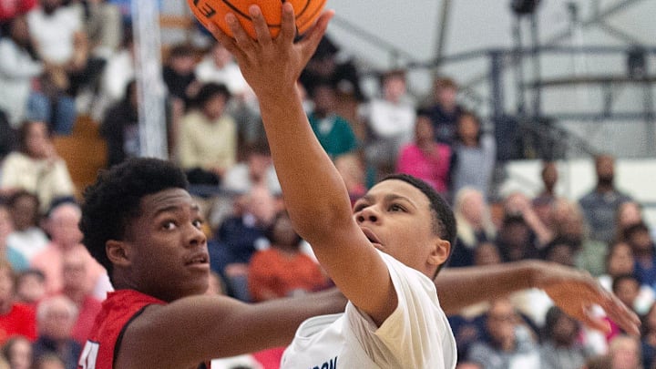 JA's Mason Williams (15) takes a shot past MRA's Erick Dampier Jr. (25) during the MAIS Overall Basketball Tournament in Clinton, Miss. JA's Mason Williams (15) takes a shot past MRA's Erick Dampier Jr. (25) during the MAIS Overall Basketball Tournament in Clinton, Miss.