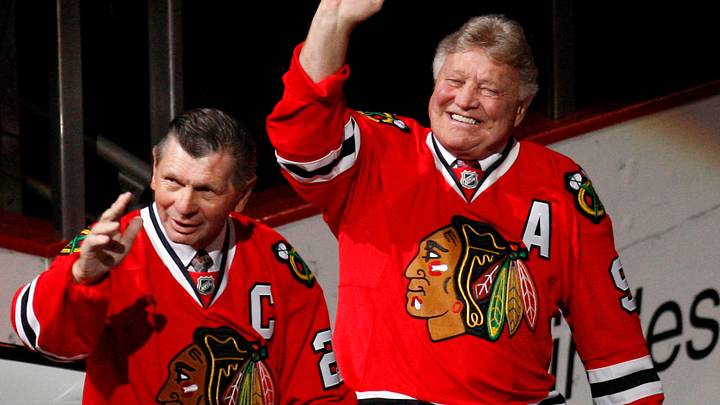Chicago Blackhawks former players Stan Mikita (21) and Bobby Hull (9) wave to the crowd as they are introduced during a ceremony honoring their careers before the game against the San Jose Sharks at the United Center.  Mandatory Credit: Jerry Lai-USA TODAY Sports