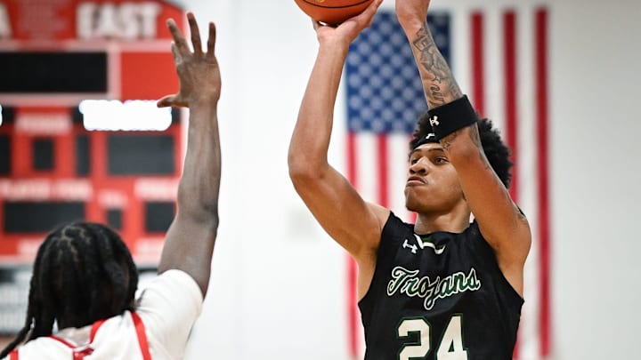 Wauwatosa West guard Jalen Brown (24) puts up a shot over Wauwatosa East guard/forward Tommie Muskgrow (4) in a game Friday, December 12, 2025, at Wauwatosa East High School in Wauwatosa, Wisconsin. West won 74-63.