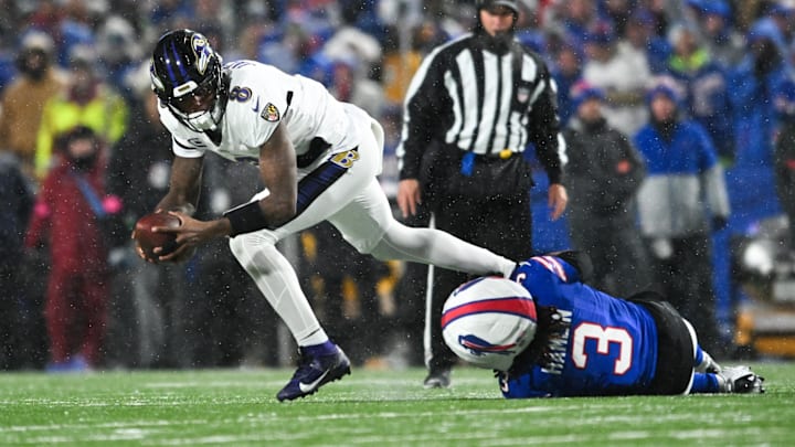 Jan 19, 2025; Orchard Park, New York, USA; Baltimore Ravens quarterback Lamar Jackson (8) runs the ball against Buffalo Bills safety Damar Hamlin (3) during the second quarter in a 2025 AFC divisional round game at Highmark Stadium. Mandatory Credit: Mark Konezny-Imagn Images