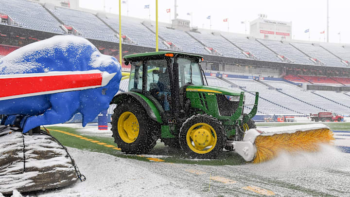 Jan 2, 2022; Orchard Park, New York, USA; Stadium staff removes snow from the field at Highmark
