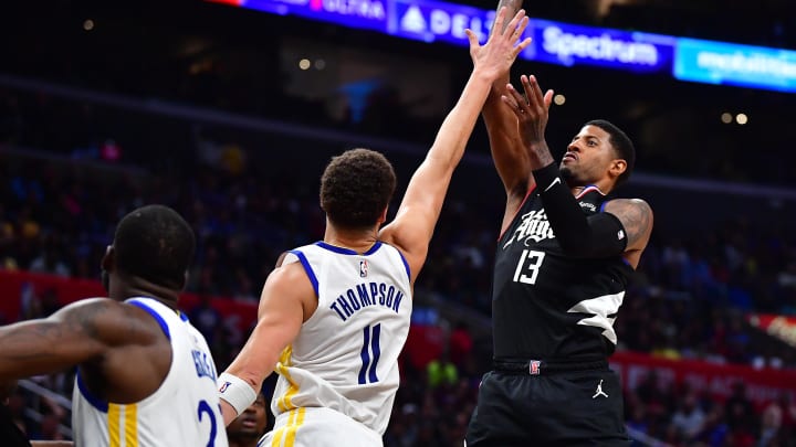 Mar 15, 2023; Los Angeles, California, USA; Los Angeles Clippers forward Paul George (13) shoots against Golden State Warriors guard Klay Thompson (11) during the second half at Crypto.com Arena. Mandatory Credit: Gary A. Vasquez-USA TODAY Sports