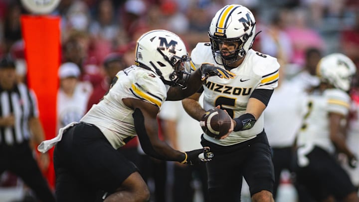 Oct 26, 2024; Tuscaloosa, Alabama, USA;  Missouri Tigers quarterback Drew Pyne (6) hands off to running back Marcus Carroll (9) against the Alabama Crimson Tide during the fourth quarter at Bryant-Denny Stadium. Mandatory Credit: Will McLelland-Imagn Images
