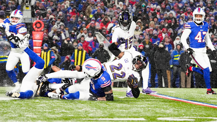 Jan 19, 2025; Orchard Park, New York, USA; Baltimore Ravens running back Derrick Henry (22) is tackled by Buffalo Bills safety Taylor Rapp (9) 