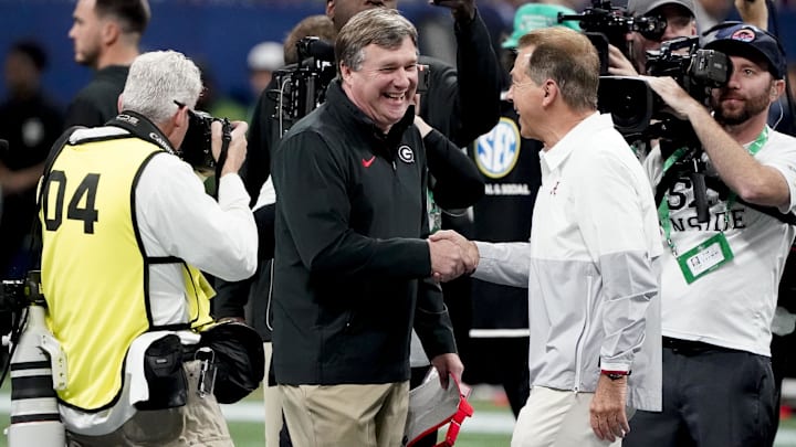 Dec 2, 2023; Atlanta, GA, USA;  Georgia Bulldogs head coach Kirby Smart and Alabama Crimson Tide head coach Nick Saban meet before the SEC Championship Game at Mercedes-Benz Stadium. Mandatory Credit: Gary Cosby Jr.-Imagn Images