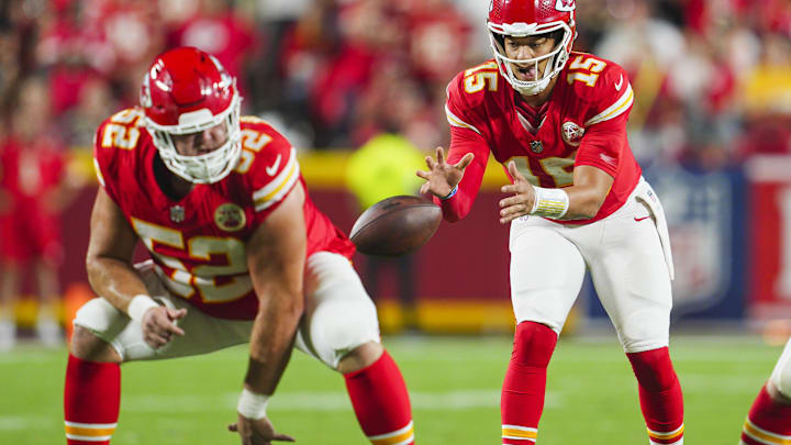 Sep 5, 2024; Kansas City, Missouri, USA; Kansas City Chiefs starting quarterback Patrick Mahomes (15) takes the snap from center Creed Humphrey (52) during the second half against the Baltimore Ravens at GEHA Field at Arrowhead Stadium. Mandatory Credit: Jay Biggerstaff-Imagn Images