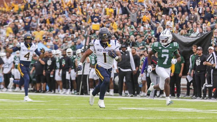 Sep 6, 2025; Athens, Ohio, USA; West Virginia Mountaineers running back Jahiem White (1) runs the ball for a touchdown during the first quarter against the Ohio Bobcats at Peden Stadium. Mandatory Credit: Ben Queen-Imagn Images