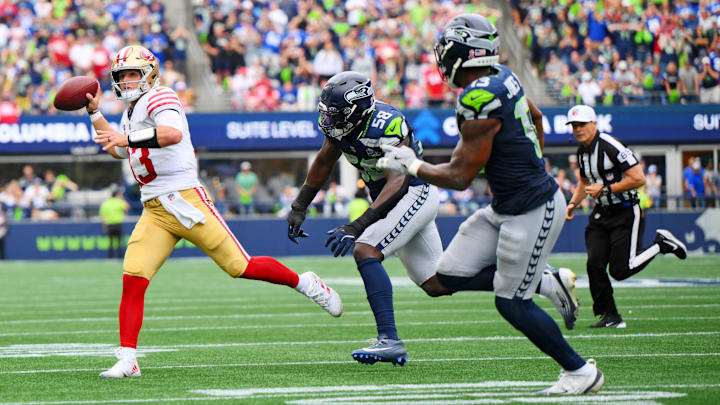 Sep 7, 2025; Seattle, Washington, USA; San Francisco 49ers quarterback Brock Purdy (13) throws a touch down pass during the second half against Seattle Seahawks at Lumen Field. Mandatory Credit: Steven Bisig-Imagn Images