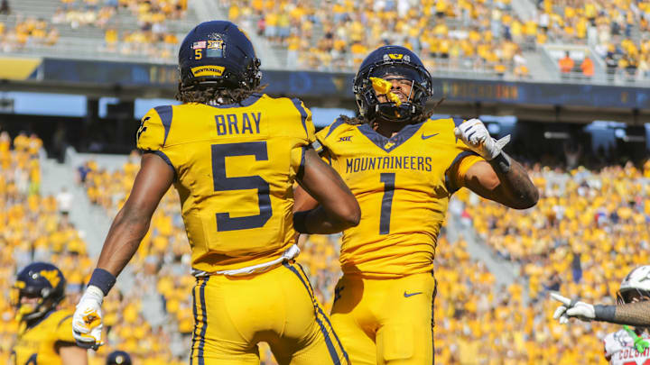 Aug 30, 2025; Morgantown, West Virginia, USA; West Virginia Mountaineers running back Jahiem White (1) scores a touchdown and celebrates with West Virginia Mountaineers wide receiver Jaden Bray (5) during the third quarter at Milan Puskar Stadium. Mandatory Credit: Ben Queen-Imagn Images