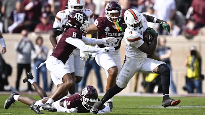 Dec 20, 2025; College Station, TX, USA; Miami Hurricanes running back Mark Fletcher Jr. (4) runs against Texas A&M Aggies cornerback Jordan Shaw (8) during the second half of the first round game of the CFP National Playoff at Kyle Field. Mandatory Credit: Jerome Miron-Imagn Images