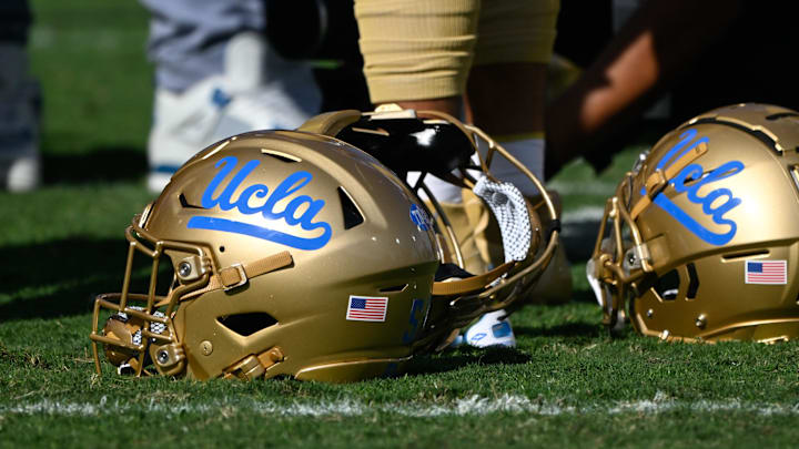 Nov 30, 2024; Pasadena, California, USA; UCLA Bruins helmets during pregame warmups before playing the Fresno State Bulldogs at Rose Bowl. Mandatory Credit: Robert Hanashiro-Imagn Images