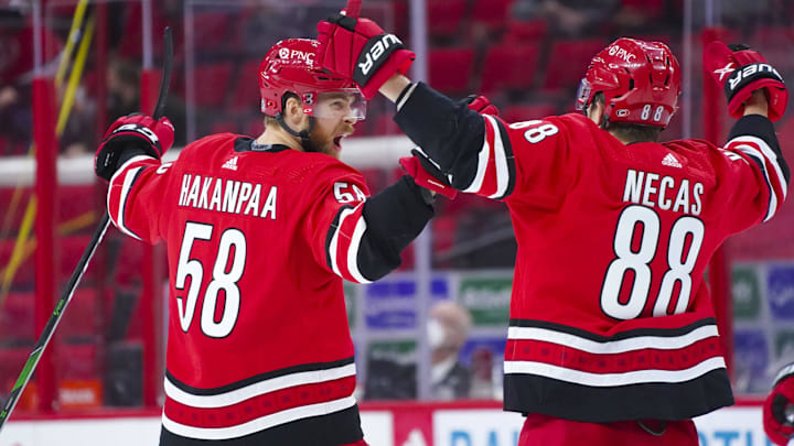 Apr 17, 2021; Raleigh, North Carolina, USA; Carolina Hurricanes defenseman Jani Hakanpaa (58) celebrates his third period goal with center Martin Necas (88) against the Nashville Predators at PNC Arena. Mandatory Credit: James Guillory-Imagn Images