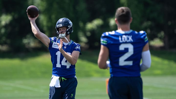 Jun 11, 2025; Renton, WA, USA; Seattle Seahawks quarterback Sam Darnold (14) passes the ball to quarterback Drew Lock (2) during mini-camp at Virginia Mason Athletic Center. Mandatory Credit: Stephen Brashear-Imagn Images Jun 11, 2025; Renton, WA, USA; Seattle Seahawks quarterback Sam Darnold (14) passes the ball to quarterback Drew Lock (2) during mini-camp at Virginia Mason Athletic Center. Mandatory Credit: Stephen Brashear-Imagn Images