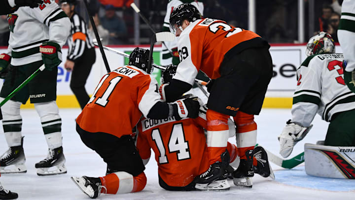Oct 26, 2024; Philadelphia, Pennsylvania, USA; Philadelphia Flyers right wing Travis Konecny (11) and Philadelphia Flyers right wing Matvei Michkov (39) celebrate with center Sean Couturier (14) after his goal against the Minnesota Wild in the third period at Wells Fargo Center.