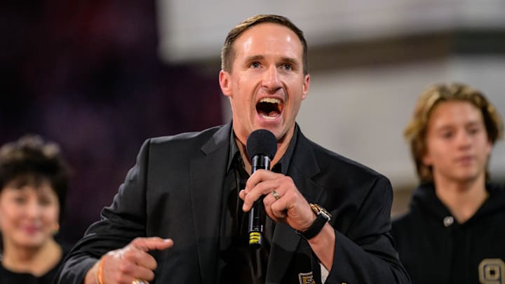 Oct 17, 2024; New Orleans, Louisiana, USA; New Orleans Saints retired quarterback Drew Brees (9) reacts during his hall of fame ceremony at halftime against the Denver Broncos at Caesars Superdome. Mandatory Credit: Matthew Hinton-Imagn Images