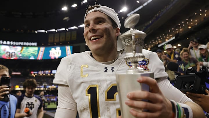 Jan 2, 2025; New Orleans, LA, USA; Notre Dame Fighting Irish quarterback Riley Leonard (13) celebrates with fans in the stands after defeating the Georgia Bulldogs at Caesars Superdome. 