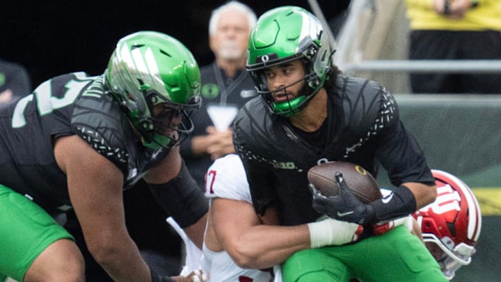 Oregon quarterback Dante Moore, right, is sacked on the opening drive of the game against Indiana at Autzen Stadium October 11, 2025.