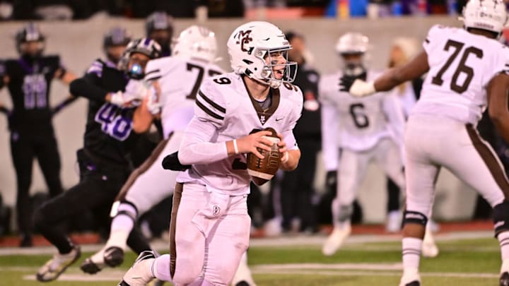 Mount Carmel QB Jack Elliott surveys the Downers Grove North defense in an Illinois high school football game in 2023.