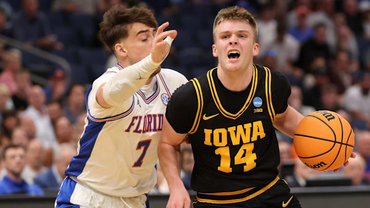 Mar 22, 2026; Tampa, FL, USA; Iowa Hawkeyes guard Bennett Stirtz (14) dribbles the ball against Florida Gators guard Urban Klavzar (7) in the first half during a second round game of the men's 2026 NCAA Tournament at Benchmark International Arena. Mandatory Credit: Matt Pendleton-Imagn Images