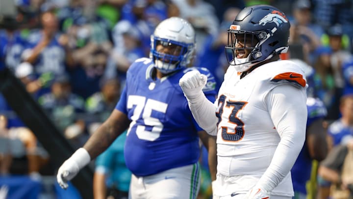 Sep 8, 2024; Seattle, Washington, USA; Denver Broncos defensive tackle D.J. Jones (93) celebrates a holding penalty against Seattle Seahawks guard Anthony Bradford (75) for a safety during the second quarter at Lumen Field.
