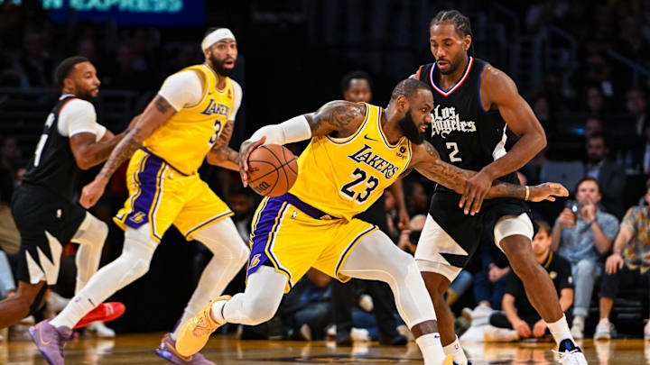 Nov 1, 2023; Los Angeles, California, USA;  Los Angeles Lakers forward LeBron James (23) dribbles the ball against LA Clippers forward Kawhi Leonard (2) during the fourth quarter at Crypto.com Arena. Mandatory Credit: Jonathan Hui-Imagn Images