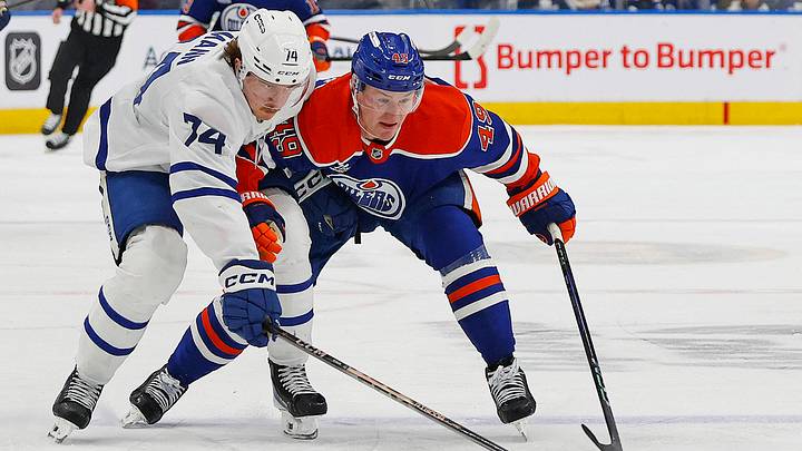 Feb 3, 2026; Edmonton, Alberta, CAN; Toronto Maple Leafs forward Bobby McMann (74) and Edmonton Oilers defensemen Ty Emberson (49) chases a loose puck during the second period at Rogers Place. Mandatory Credit: Perry Nelson-Imagn Images