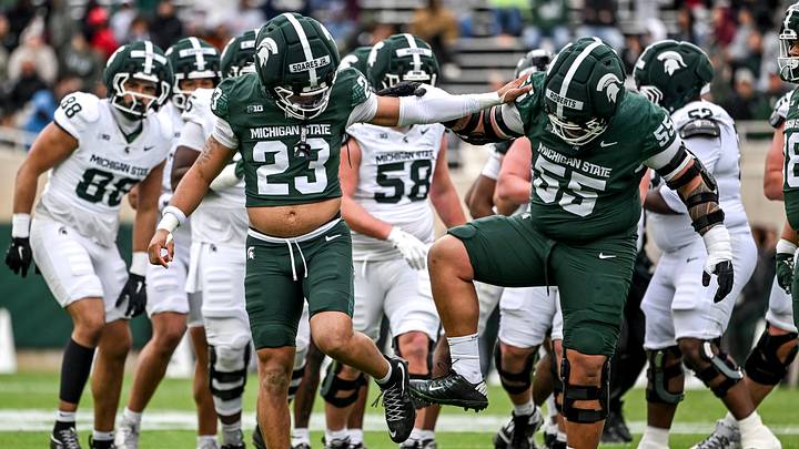 Michigan State's Kenny Soares Jr., left, and Ben Roberts clean the dirt off their cleats during the football Spring Showcase on Saturday, April 18, 2026, at Spartan Stadium in East Lansing.
