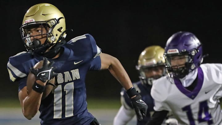 Hoban's Elbert Hill IV outruns Barberton's Trent DeWitt to score a touchdown during a Division II regional quarterfinal, Friday, Nov. 3, 2023.