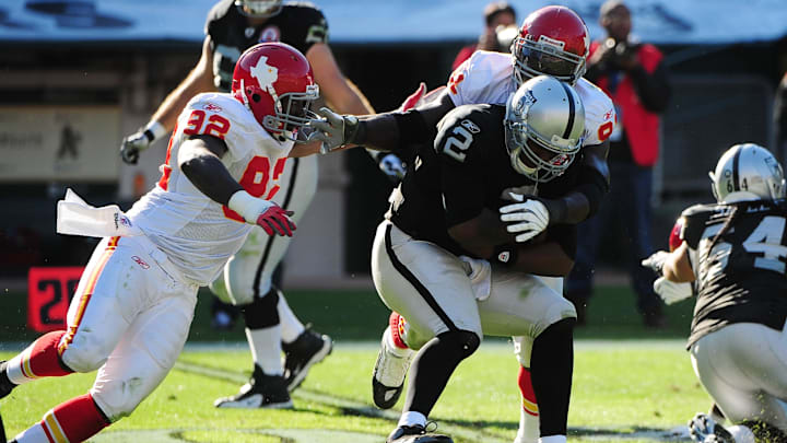 November 15, 2009; Oakland, CA, USA; Oakland Raiders quarterback JaMarcus Russell (2) is sacked by Kansas City Chiefs defensive end Wallace Gilberry (left) and linebacker Tamba Hali (right) during the second quarter at Oakland-Alameda County Coliseum. Mandatory Credit: Kyle Terada-USA TODAY Sports