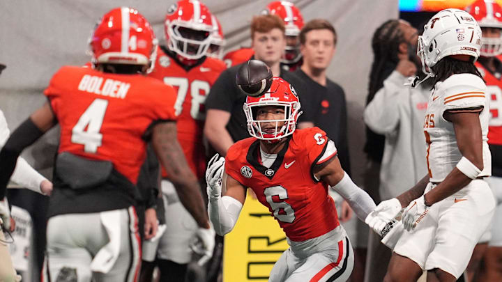 Dec 7, 2024; Atlanta, GA, USA; Georgia Bulldogs defensive back Daylen Everette (6) makes an interception against Texas Longhorns wide receiver Isaiah Bond (7) during the first half in the 2024 SEC Championship game at Mercedes-Benz Stadium. Mandatory Credit: Dale Zanine-Imagn Images